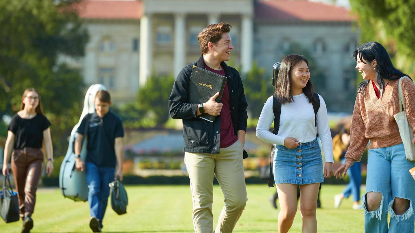 Media masthead - Music students walking in front of admin building